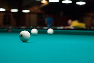 Russian billiard in club: balls on green game table cloth