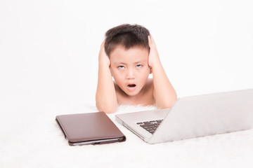 Serious asian Baby Boy with Laptop and tablet Isolated on the white background.