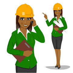 female african american architect wearing yellow safety helmet holding blueprints and clipboard talking on phone