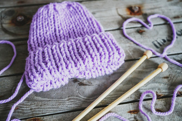 lilac knitted hat, handmade knitting needles and yarn