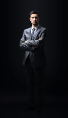 Handsome businessman isolated on black