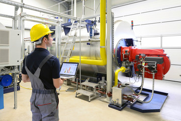 Wartung in einer Industrieanlage: Arbeiter checkt das System auf Funktion - obrazy, fototapety, plakaty