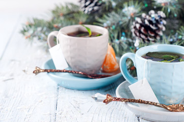 two tea cups with teabag and xmas tree