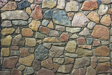 wall of granite boulders of different colors
