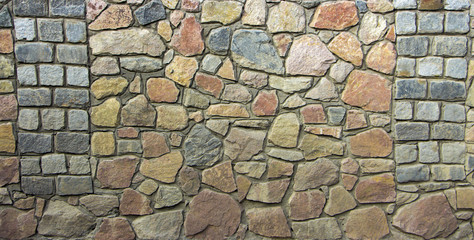 wall of granite boulders of different colors