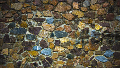 wall of granite boulders of different colors