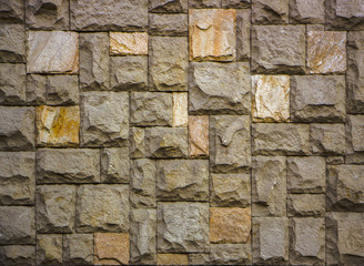 house wall decorated with multi-colored sandstone wall tiles