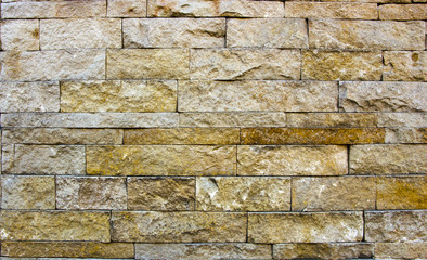 house wall decorated with multi-colored sandstone wall tiles