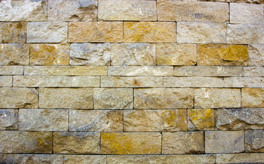 house wall decorated with multi-colored sandstone wall tiles