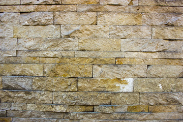 house wall decorated with multi-colored sandstone wall tiles