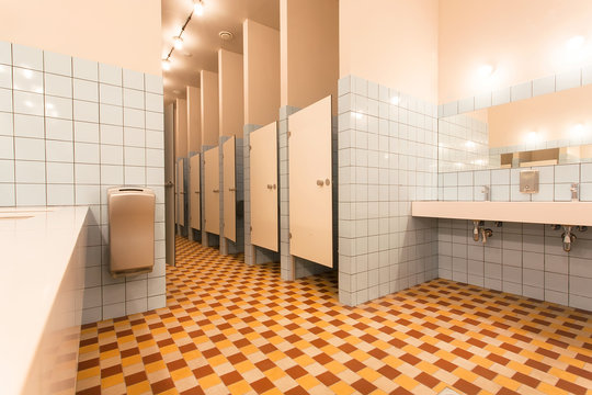 Modern interior of the hostel bathroom with toilet cabins