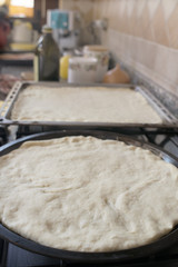 raw dough for pizza in baking tray