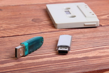 flash disk and audio cassette on wooden background