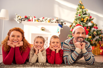 Joyful parents and children celebrating winter holiday