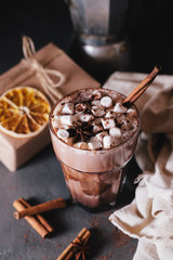 Cocoa or latte or hot chocolate with marshmallow and flavored with cinnamon. On a gray concrete background. Christmas present. Christmas concept. Christmas holiday.