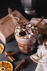 Cocoa or latte or hot chocolate with marshmallow and flavored with cinnamon. On a gray concrete background. Christmas present. Christmas concept. Christmas holiday.