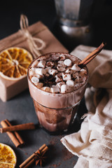 Cocoa or latte or hot chocolate with marshmallow and flavored with cinnamon. On a gray concrete background. Christmas present. Christmas concept. Christmas holiday.