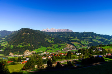 Beautiful alpine summer landscape. Mountains and sun, blue sky,