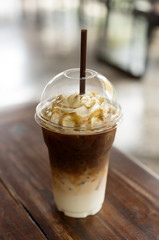 Iced coffee with caramel syrup and whipped cream