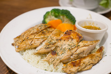 garlic rice with fried chicken on wood table
