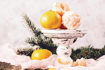 Greeting Card with Tangerines as Fir-tree Toy and Branch of Coniferous on Snow, toned square image