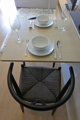 wood tables and rattan chairs with coffee cup , wine glass set