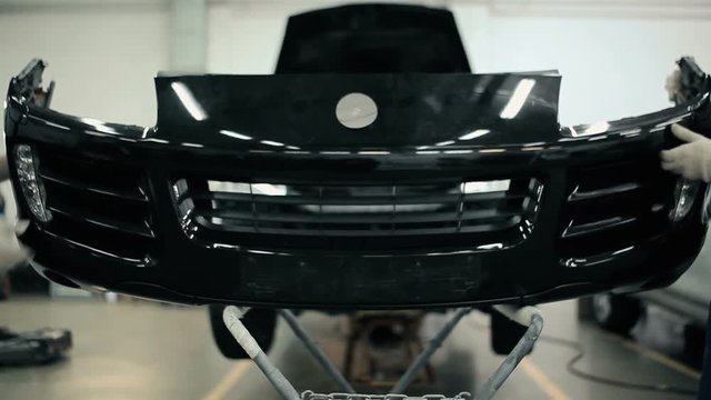 Men put on the bumper bar.