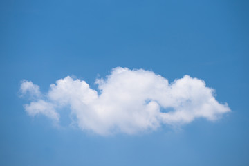 Naklejka na ściany i meble Beautiful single white cloud on blue sky