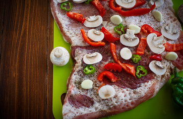 raw meat with spices, vegetables and mushrooms