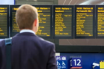 Printed kitchen splashbacks Train station Commuter checking digital timetables at a train station