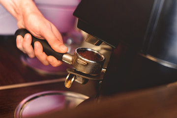 barman preparing apparatus to make a coffee
