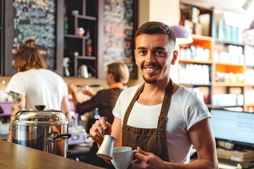 cheerful bartender smiling in a cafe