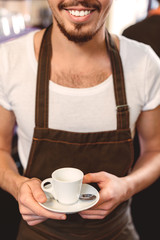 selective focus on the mug in hands of barman