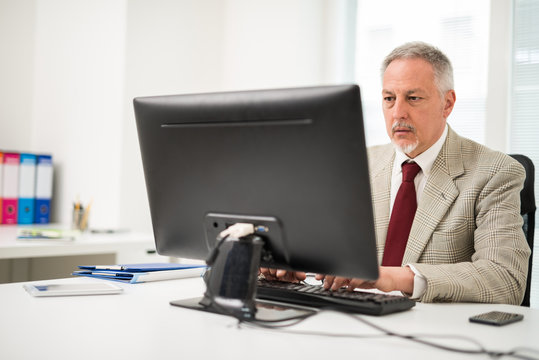 Businessman using his desktop computer