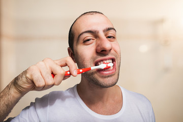 Portrait of a man cleaning his teeth