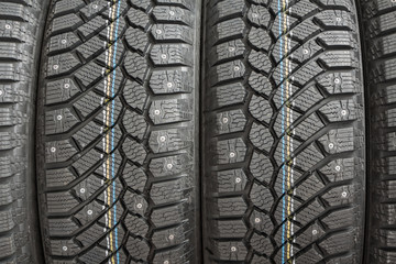 Fototapeta premium Winter car tires with snow spikes, closeup