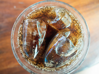 glass of cola with ice top view.
