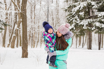 Happy mother and baby in winter park