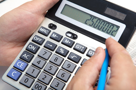 Businessman with calculator in the office