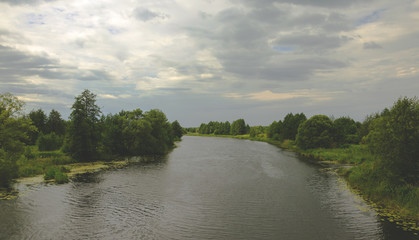 Cloudy summer landscape with river