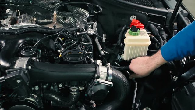 The man opens the cap on the pipe.