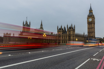 Fototapeta na wymiar Red bus in motion and Big Ben, the Palace of Westminster. London, the UK.