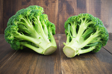 Raw broccoli on wooden table