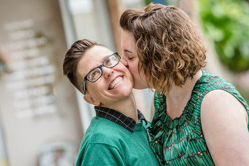 Lesbian couple kissing outdoors