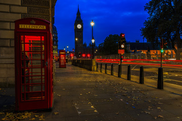 Fototapeta na wymiar Red telephone booth and Big Ben in London, UK. The symbols of London