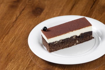 puff pastry in a round white plate on a wooden surface with reflection