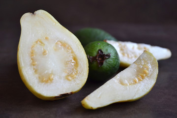 Fruit background. Guava, feijoa , on dark background. Collection of fruits.

