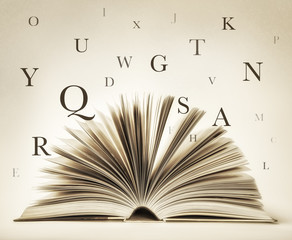 open book with flying letters