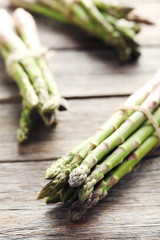 Fresh green asparagus on a grey wooden table