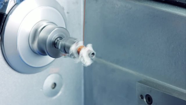 close-up shot of a copper coil winding machine manufacturing a storage choke